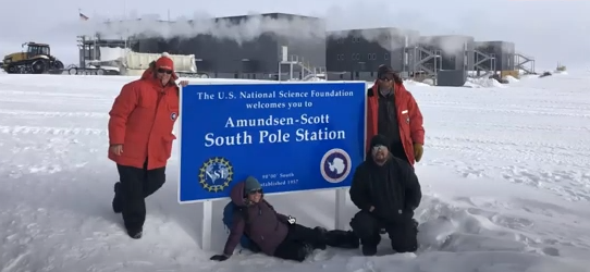 Kelly Brunt and others pose with the "Amundsen-Seott South Pole Station"