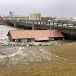 A building lifted from its foundation by floodwater from Extratropical Typhoon Merbok, trapped under a bridge in Nome, Alaska. Source: Coastal and Marine Hazards and Resources Program