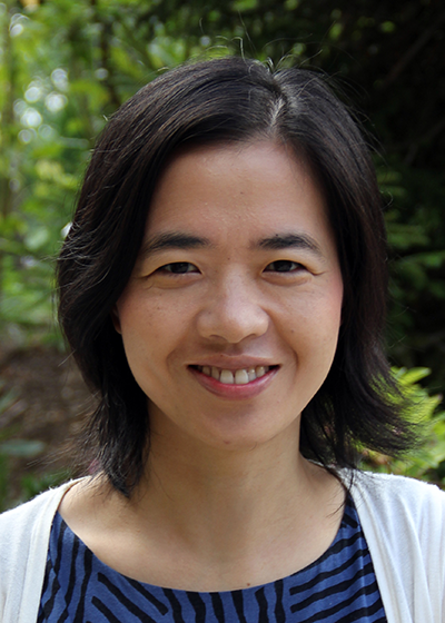 Li Li's headshot, depicting her smiling in front of a green backdrop