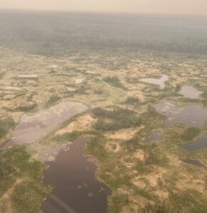 Permafrost thaw bogs in the Northwest Territories, Canada. A nearby fire caused haze in the scene. Photos were taken from a helicopter.
