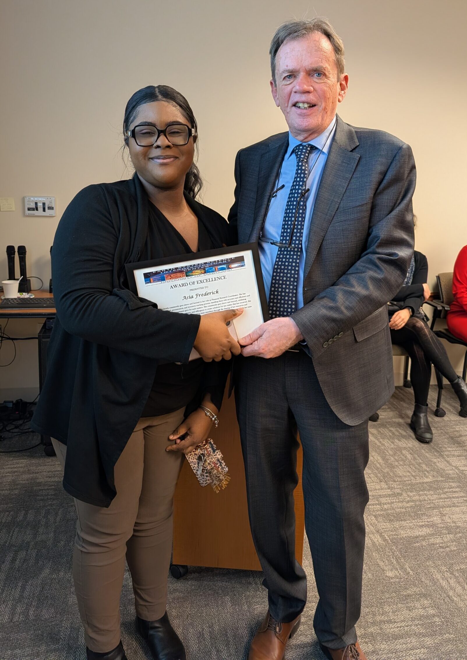 Asia Frederick shaking hands with Lars Peter Riishojgaard