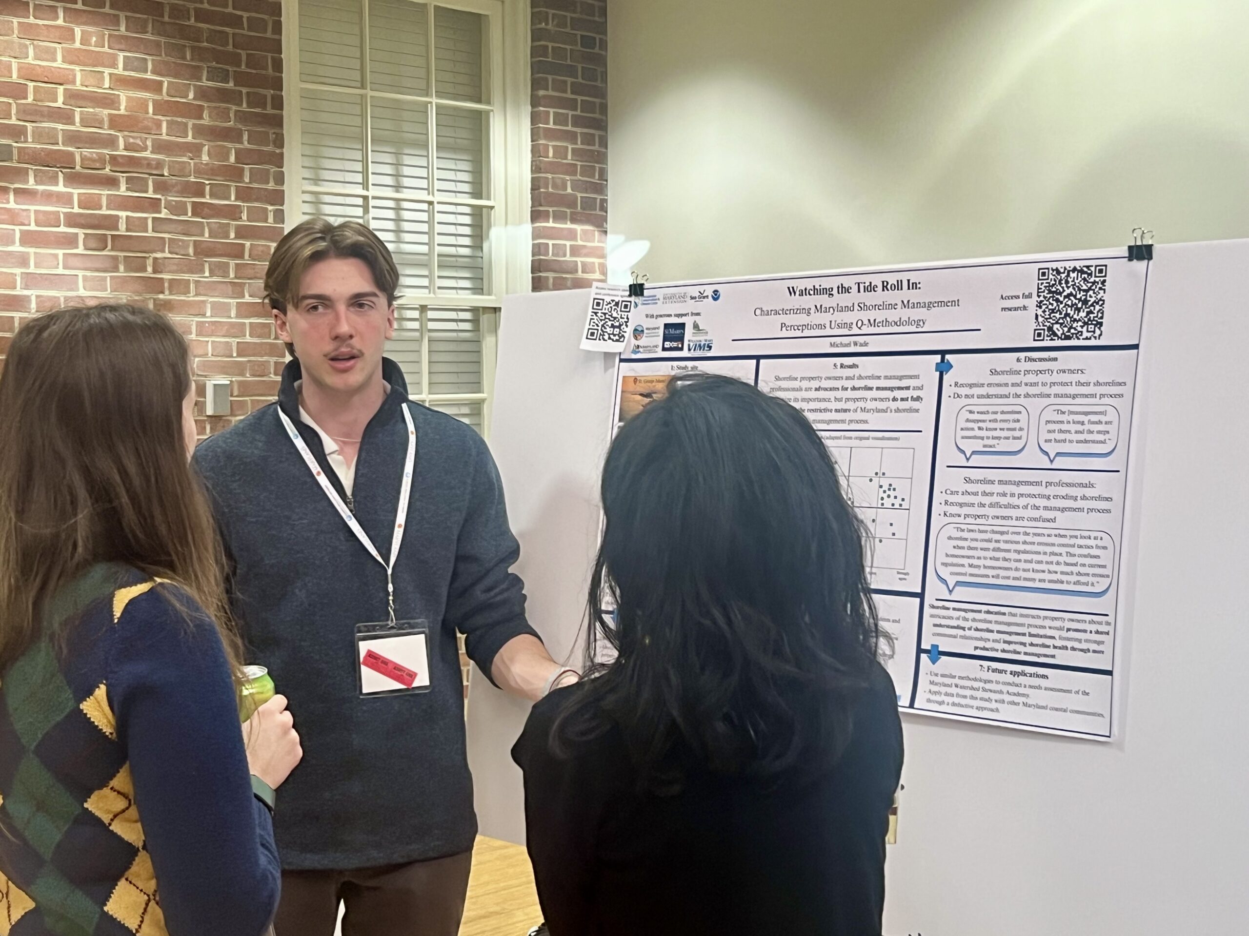 Student Michael Wade presents his work at the poster presentation. Mentor: Parisa Rinaldi. Photo by Jennifer Collins.